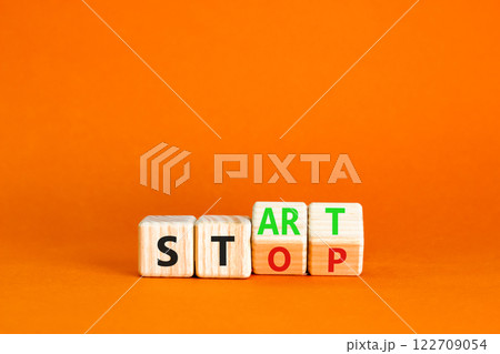 Start or stop symbol. Concept words Start or Stop on beautiful wooden block. Beautiful orange table orange background. Business start or stop concept. Copy space. 122709054