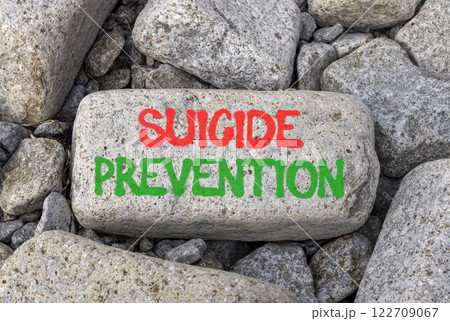 Suicide prevention symbol. Concept words Suicide prevention on beautiful big grey stone. Beautiful grey stones background. Psychological and suicide prevention concept. Copy space. Suicide prevention symbol. Concept words Suicide prevention on beautiful big grey stone. Beautiful grey stones background. Psychological and suicide prevention concept. Copy space. 122709067