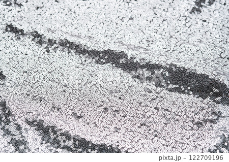 Abstract festive fabric texture with silver sequins. Abstract festive fabric texture with silver sequins. 122709196