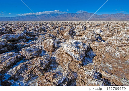 Rugged salt formations of Devils Golf Course under a bright blue sky 122709479