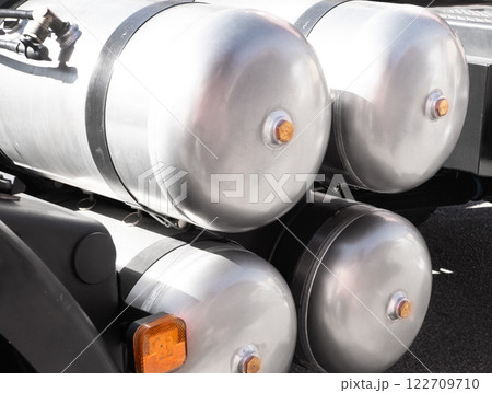 Air brake system of the truck. Black receivers with compressed air. Parts of a truck close-up. Heavy duty truck compressed air tanks. Air brake system of the truck 122709710