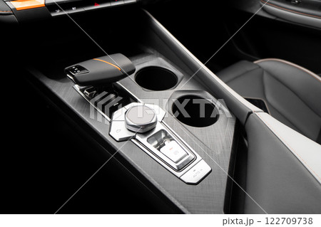 Automatic gear in car. Modern car interior details. Close up view. Automatic transmission lever shift. Black leather interior with stitching Automatic gear in car. Modern car interior details. Close up view. Automatic transmission lever shift. Black leather interior with stitching 122709738