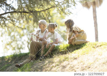 Family enjoying a sunny day outdoors together Family enjoying a sunny day outdoors together 122709927