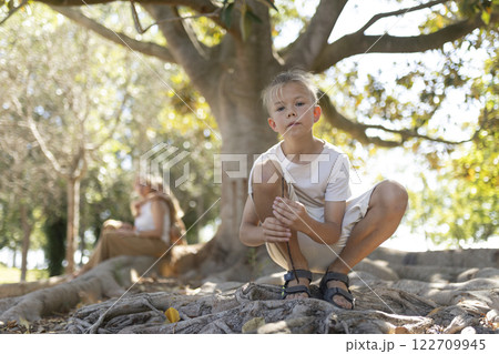 Child exploring nature with curious expression Child exploring nature with curious expression 122709945