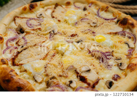 Gourmet pizza with grilled chicken, mushrooms, red onion, quail eggs, and parmesan Gourmet pizza with grilled chicken, mushrooms, red onion, quail eggs, and parmesan 122710134