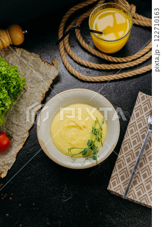 Creamy mashed potatoes garnished with fresh microgreens, in stylish and elegant food presentation Creamy mashed potatoes garnished with fresh microgreens, in stylish and elegant food presentation 122710163