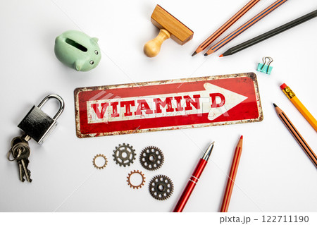 Vitamin D. Red direction arrow with text on white office desk 122711190