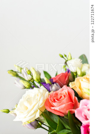 A beautiful bouquet of vibrant roses, eucalyptus, and delicate eustoma in white, pink, and purple hues, perfect for a summer anniversary or birthday celebration 122711674