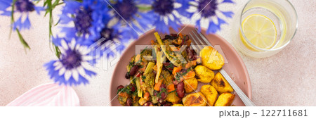 Stewed potatoes with stewed vegetables, broccoli and beans with carrots and herbs 122711681