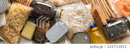 Canned goods, cereals, and pasta stored for quarantine and isolation, ensuring long-term survival and food security at home, survival during military operations, the concept of stay at home, banner Canned goods, cereals, and pasta stored for quarantine and isolation, ensuring long-term survival and food security at home, survival during military operations, the concept of stay at home, banner 122711811