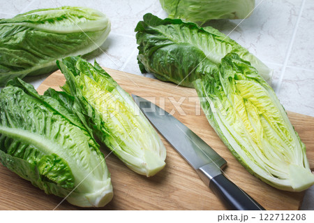 roman lettuce on cutting board roman lettuce on cutting board 122712208