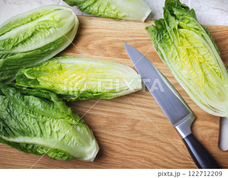 roman lettuce on cutting board roman lettuce on cutting board 122712209