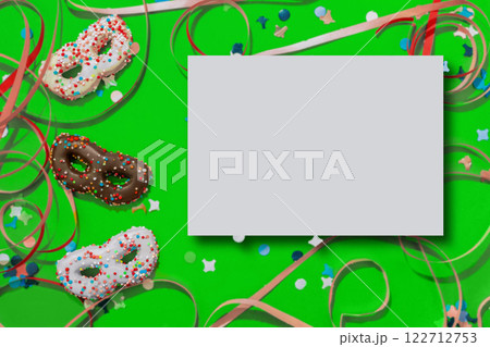 Greeting card for carnival or birthday with cookies in the shape of a mask and mock up 122712753