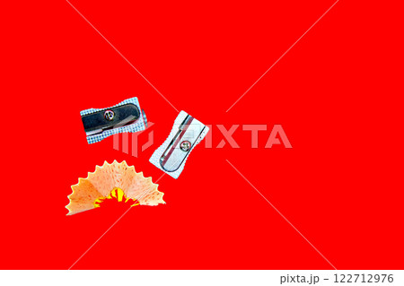 Pencil sharpener isolated on red background. Office supplies, back to school Pencil sharpener isolated on red background. Office supplies, back to school 122712976