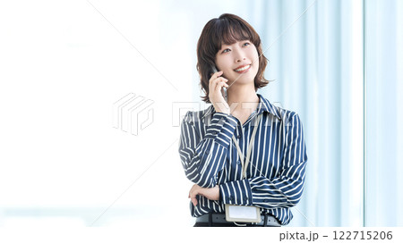 スマートフォンで話す笑顔の女性・ビジネスウーマン スマートフォンで話す笑顔の女性・ビジネスウーマン 122715206
