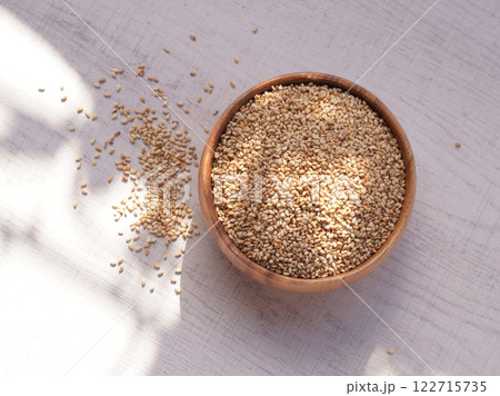 Top view of sesame in wooden bowl on white background. Copy space 122715735