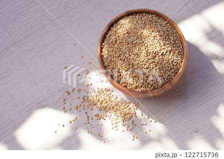 Top view of sesame in wooden bowl on white background. Copy space 122715736