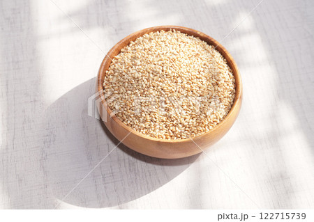 Top view of sesame in wooden bowl on white background. Copy space 122715739