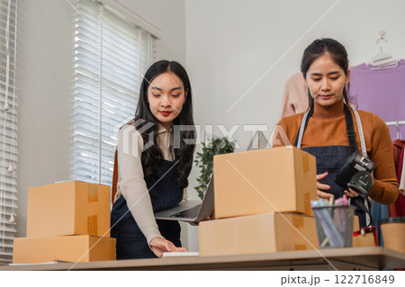 Diverse couple managing online orders and packaging in their boutique workspace. Diverse couple managing online orders and packaging in their boutique workspace. 122716849