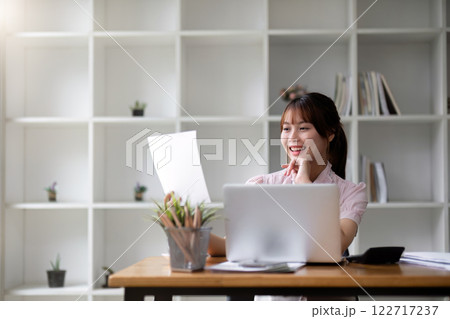 Successful Asian businesswoman dealing with business, finance, and business calculations in the office 122717237