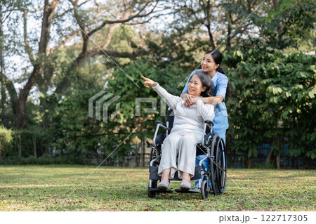 Nurse and Elderly Patient Enjoying a Peaceful Moment in the Garden Together 122717305
