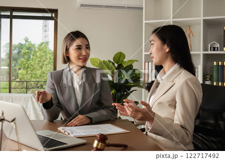 A lawyer and a businesswoman are discussing legal advice on signing a business contract. Signing an insurance or financial contract 122717492