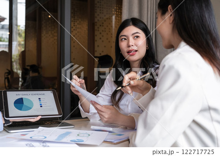 A team of business people brainstorm together about a work plan. Business management and discussing ways to work together in the meeting room A team of business people brainstorm together about a work plan. Business management and discussing ways to work together in the meeting room 122717725