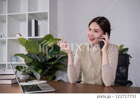 Asian college student sit at home studying online using a video calling program on their laptop. Asian college student sit at home studying online using a video calling program on their laptop. 122717731