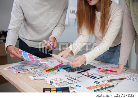 Creative designer team meeting on application design and ux ui usability planning. business team teamwork. Creative designer team meeting on application design and ux ui usability planning. business team teamwork. 122717832