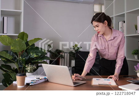 Asian business woman checks and holds online work meeting on laptop Work from home during the holidays Asian business woman checks and holds online work meeting on laptop Work from home during the holidays 122718047