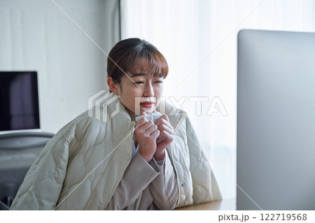 寒すぎるオフィスで凍える女性 122719568