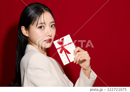 ギフトボックスを持つファッショナブルな若い女性 ギフトボックスを持つファッショナブルな若い女性 122721075