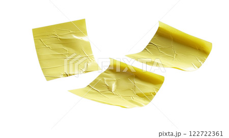 a image of three yellow sticky notes arranged on a plain background. The notes appear slightly crumpled and have a realistic texture 122722361