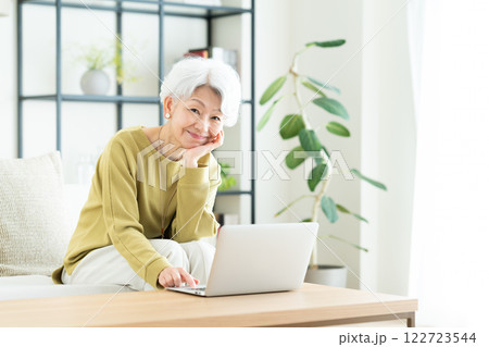 リビングでパソコンを使うシニアの女性 122723544
