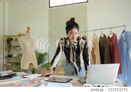 Young clothing designer envisions new ideas in studio. 122723772