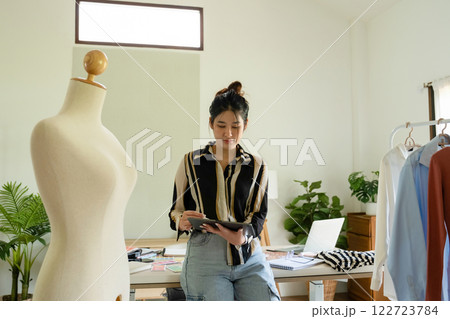 Young clothing designer working with tablet. 122723784