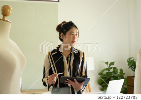 Young clothing designer working with tablet. 122723785
