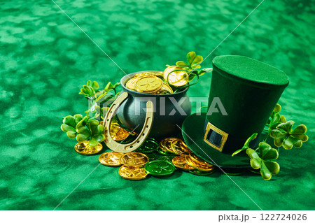 St. Patrick's Day Treasures. Green hat with gold coins, lucky clovers, and a pot 122724026