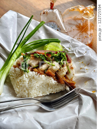 Hot red pork rice wrapped in paper is ready and placed on the dining table Hot red pork rice wrapped in paper is ready and placed on the dining table 122725594