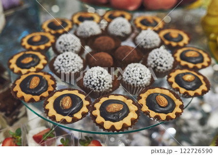 delicious colorful cookies and cakes on the wedding candy bar. 122726590