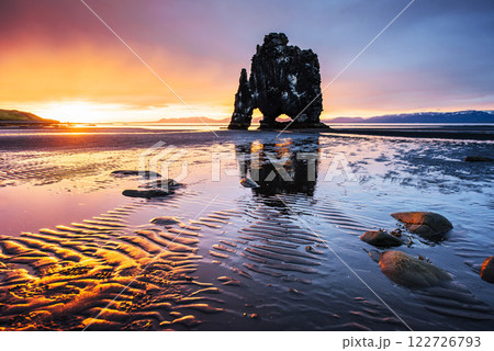 Is a spectacular rock in the sea on the Northern coast of Iceland. Legends say it is a petrified troll. On this photo Hvitserkur reflects in the sea water after the midnight sunset 122726793