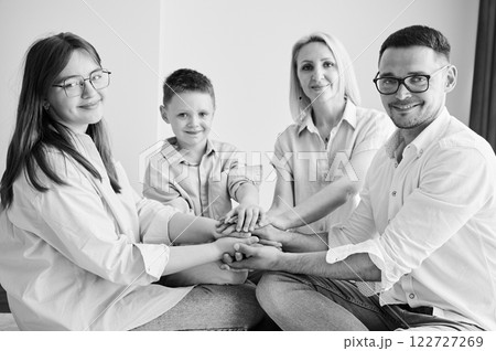 Portrait of family like big and supportive team. Parents showing to kids their support. Family playing games at home. Black and white image. Portrait of family like big and supportive team. Parents showing to kids their support. Family playing games at home. Black and white image. 122727269