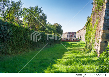 uzhhorod, ukraine - 08 aug, 2012: moat of medieval castle. sunny weather. massive stone wall and bastion. popular travel destination 122727351