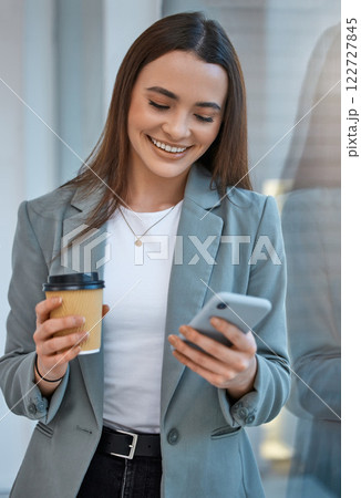 Business woman communication on phone with social media app, web internet technology and coffee cup break in startup company. Happy, smile and content office worker reading funny mobile notification Business woman communication on phone with social media app, web internet technology and coffee cup break in startup company. Happy, smile and content office worker reading funny mobile notification 122727845