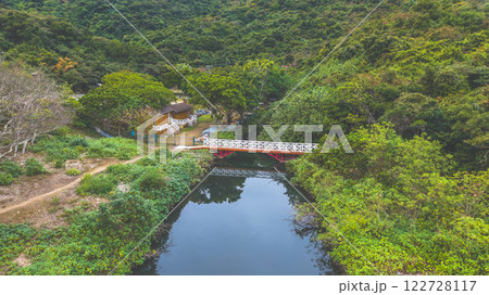 Feb 1 2025 Scenic Bridge Over a Calm River Amidst Lush Green Forest 122728117
