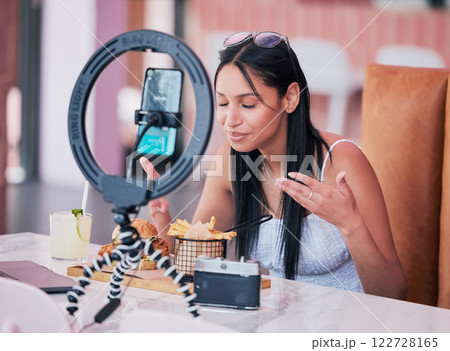 Social media influencer, smartphone and ring light for new fast food restaurant test for internet, web and followers. Creative online communication with digital mobile tech for startup video blog Social media influencer, smartphone and ring light for new fast food restaurant test for internet, web and followers. Creative online communication with digital mobile tech for startup video blog 122728165