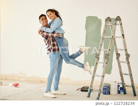 Love, a mortgage and a new home, couple paint a wall in a house green. Security, home finance and investment, a happy marriage and family fun. New beginning and bright future for young man and woman. 122728239
