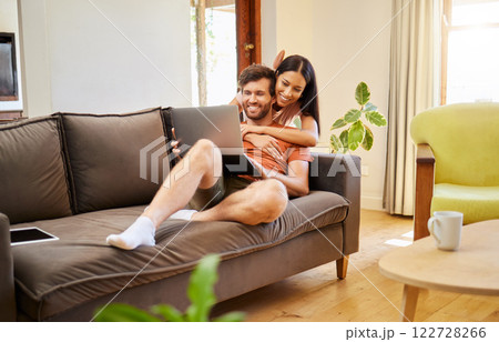 Relax, love and laptop with a couple on the internet at home together on the weekend. Diverse, young and happy man and woman relaxing in the living room and browsing the internet during the day Relax, love and laptop with a couple on the internet at home together on the weekend. Diverse, young and happy man and woman relaxing in the living room and browsing the internet during the day 122728266