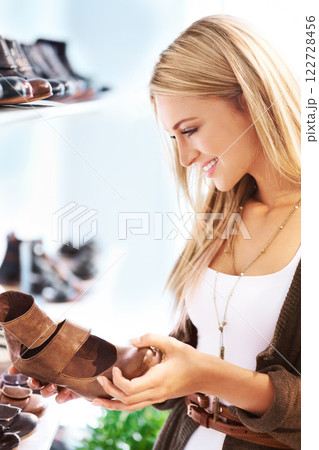 Shoes sale, retail discount and shopping of a happy woman customer looking at shop stock. Fashion boutique and clothing store with a young woman smile, happy and excited to buy, shop and purchase 122728456