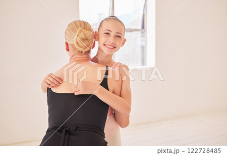 Ballet teacher giving happy student hug at dance studio, girl learning dancing art at school with coach and training for professional performance. Portrait of girl and woman hugging for motivation 122728485